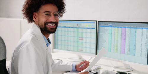 Close-up of a medical professional working on medical coding and billing tasks in an office setting, processing healthcare claims.